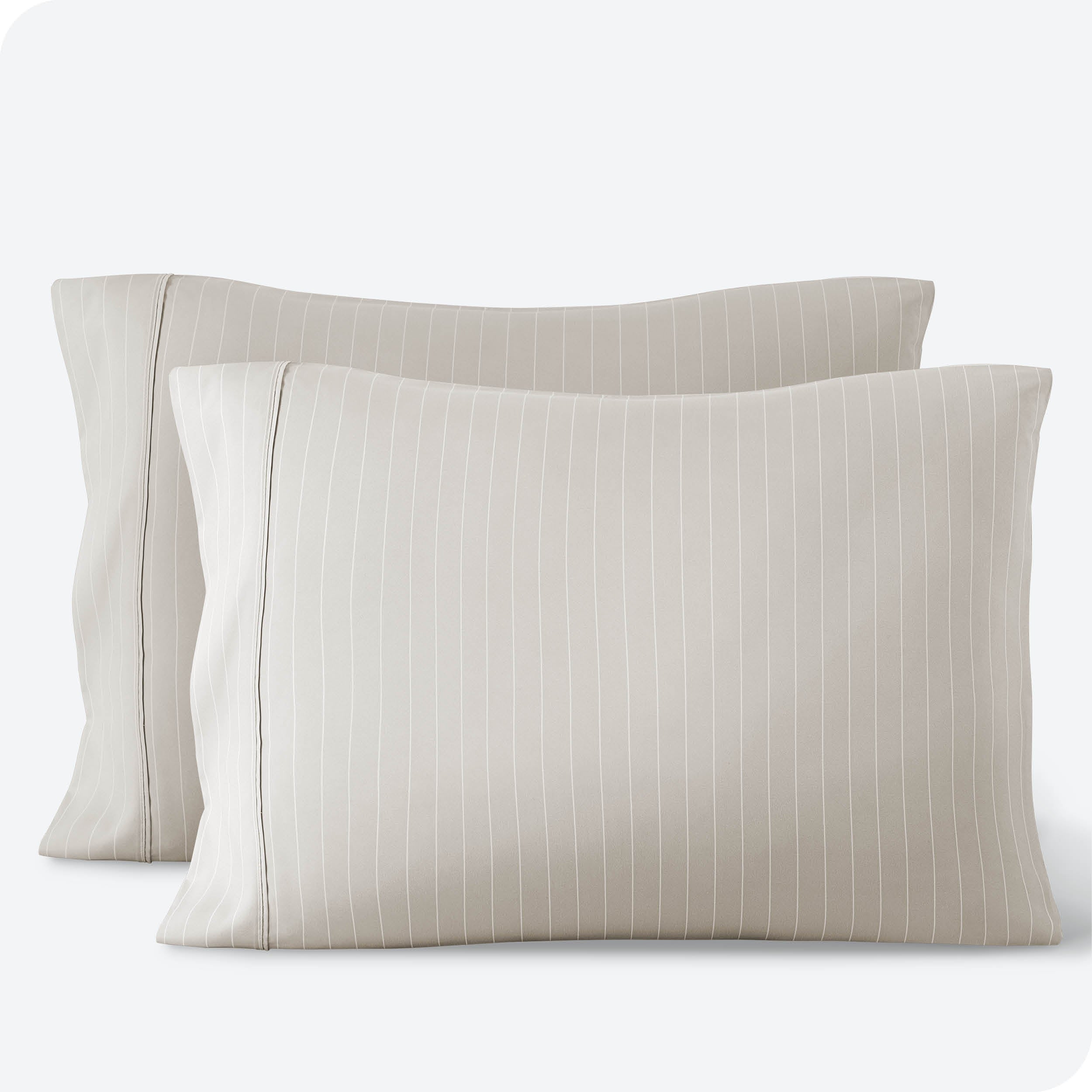 Two pillows on a white background with print pillowcases on them