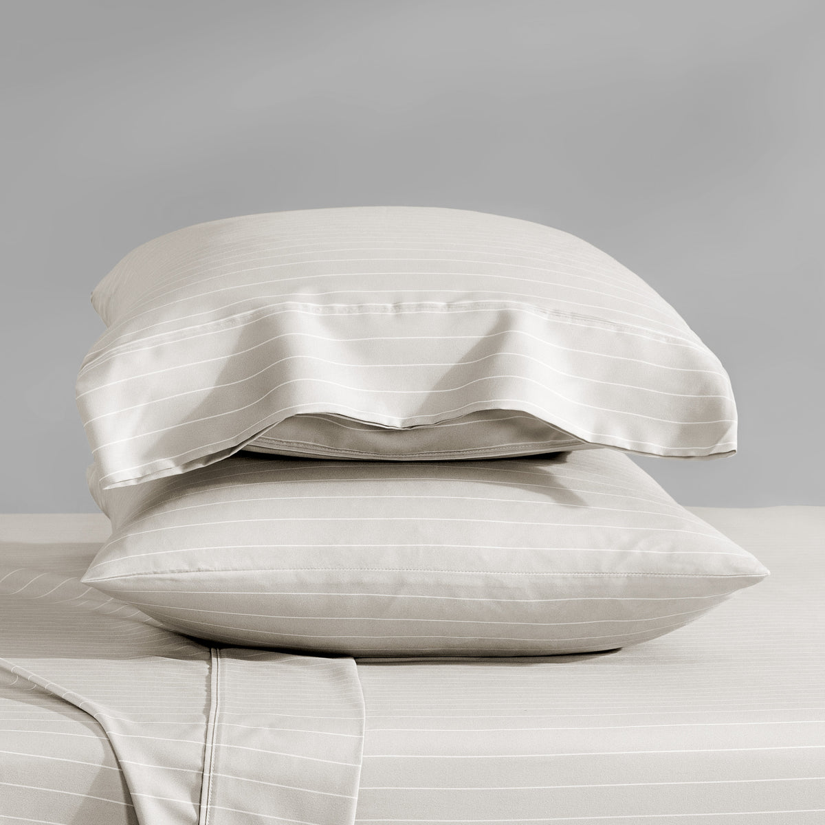 Two stacked pillowcases on a bed