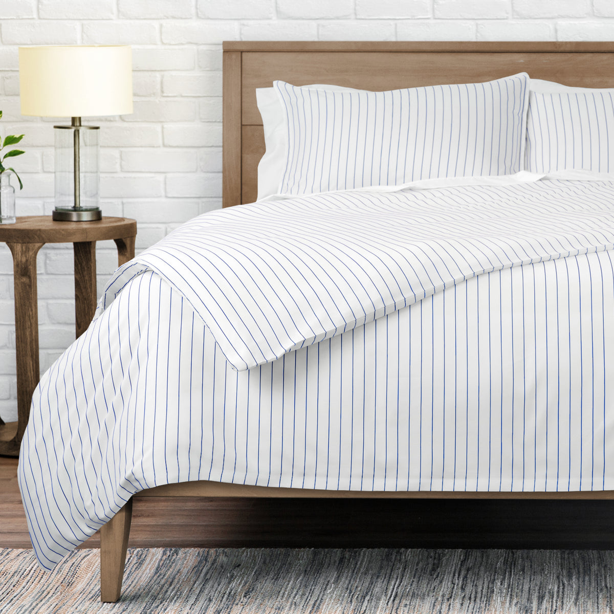 White bedding set with thin blue vertical pinstripes