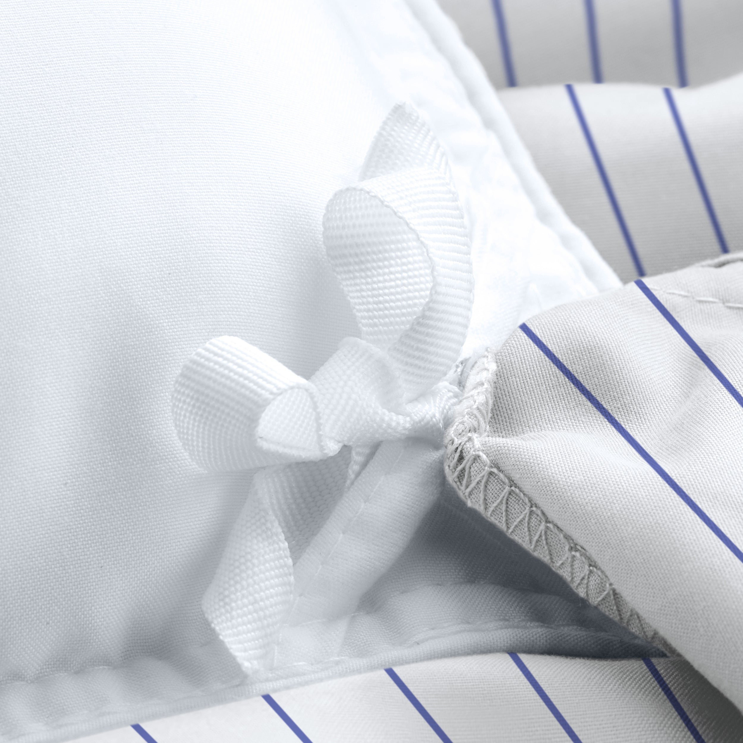 Close-up of a pinstripe duvet cover with corner ties