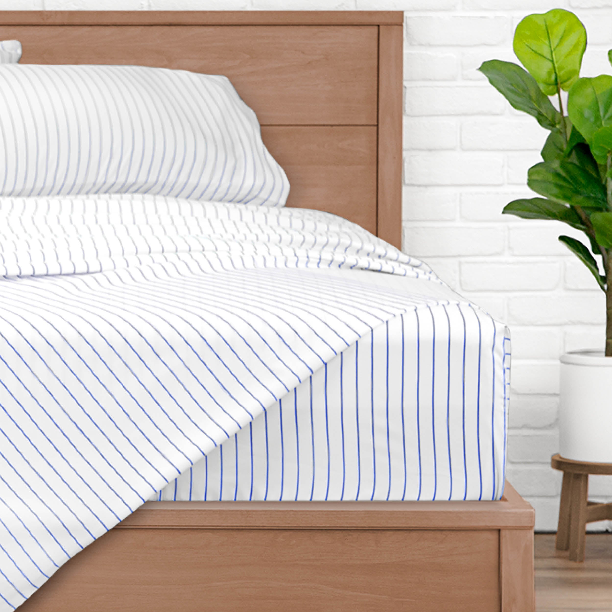 A bed made with pinstripe sheets