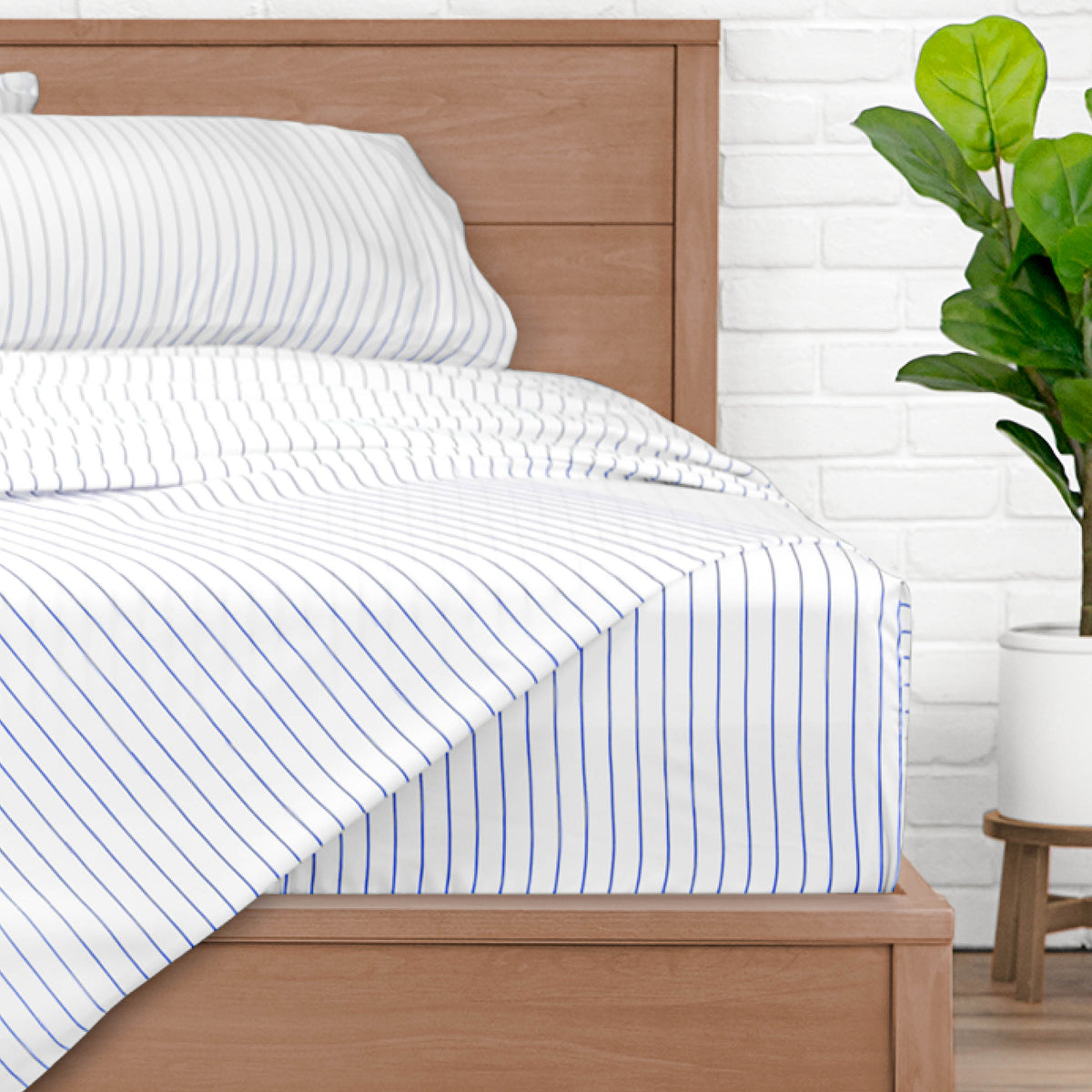 A bed made with pinstripe sheets