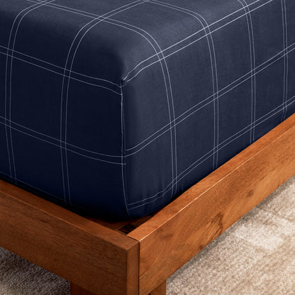 The corner of a mattress with a printed fitted sheet on it