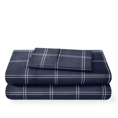 Folded navy blue plaid blanket on a white background