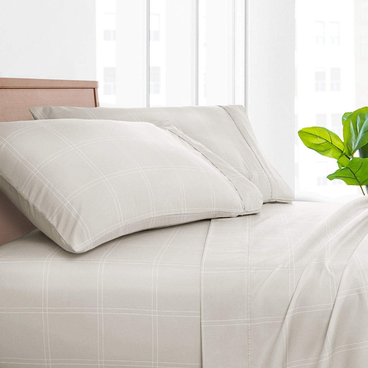 Printed bed sheet set on a bed with a white background