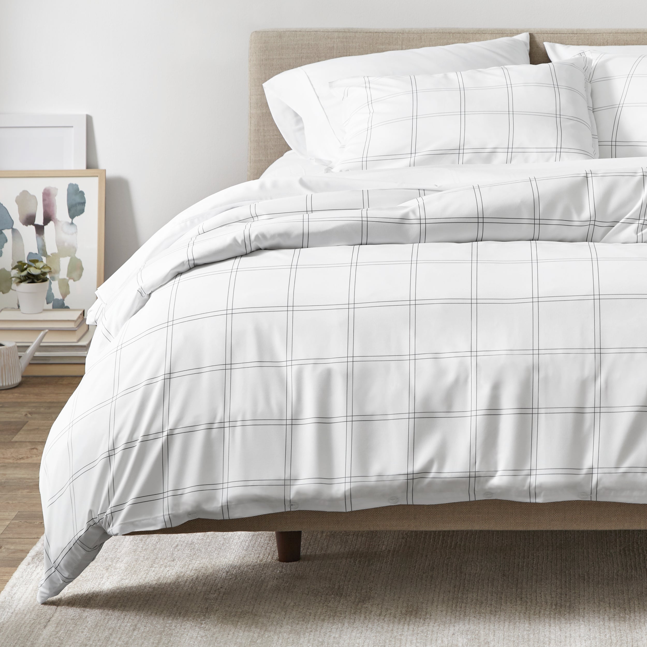 White and gray plaid duvet on a bed in a bedroom setting