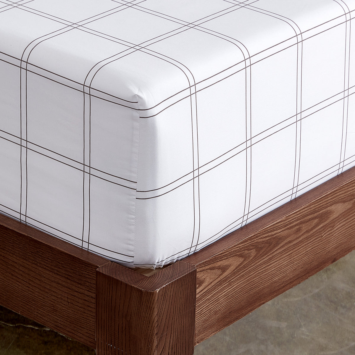 The corner of a mattress with a printed fitted sheet on it