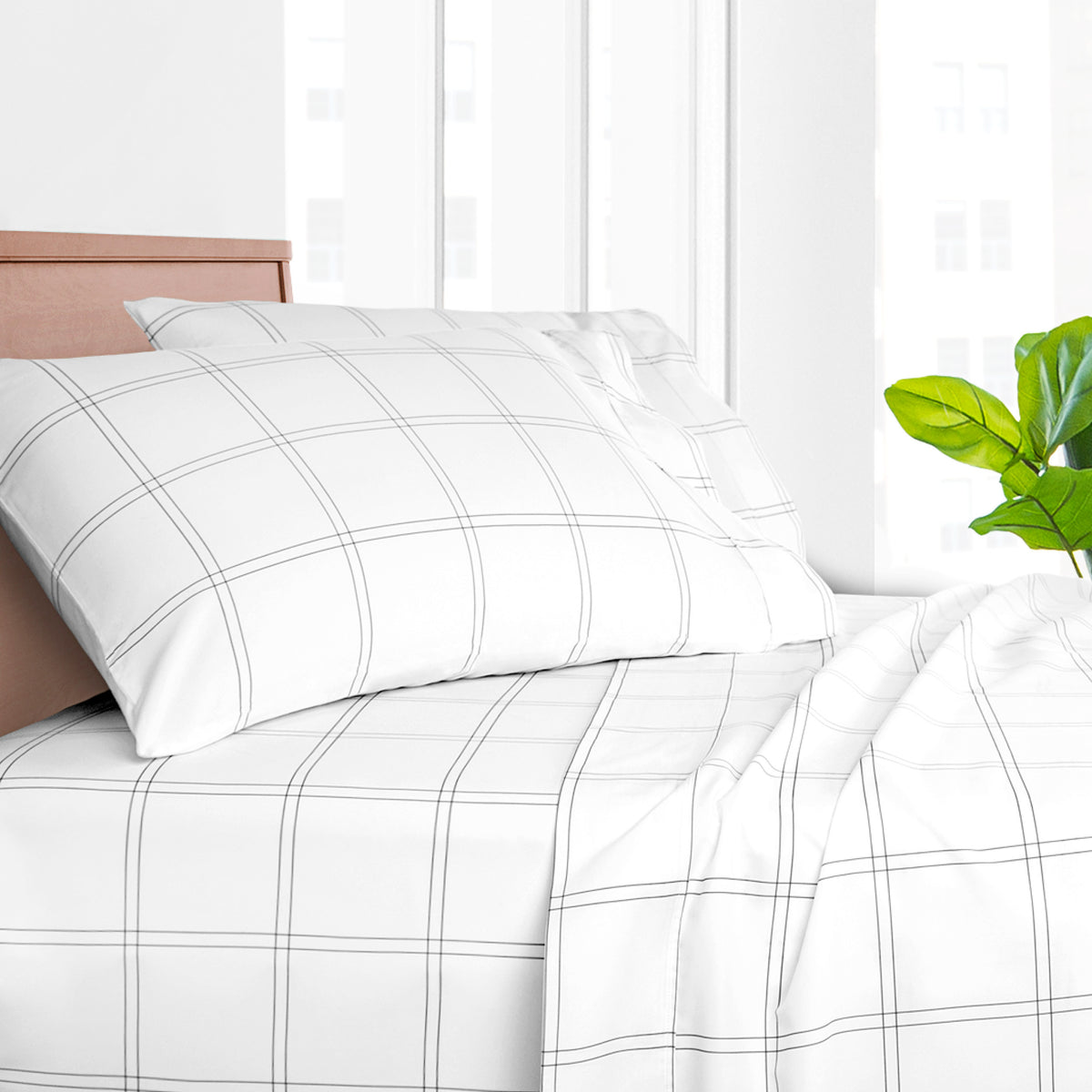 Printed bed sheet set on a bed with a white background