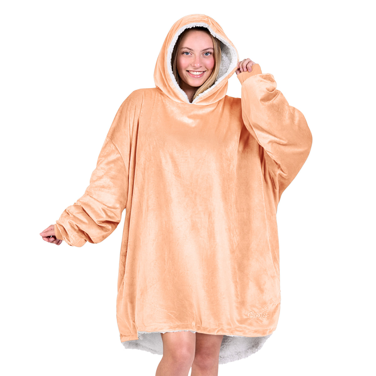 An adult with a sherpa wearable blanket on