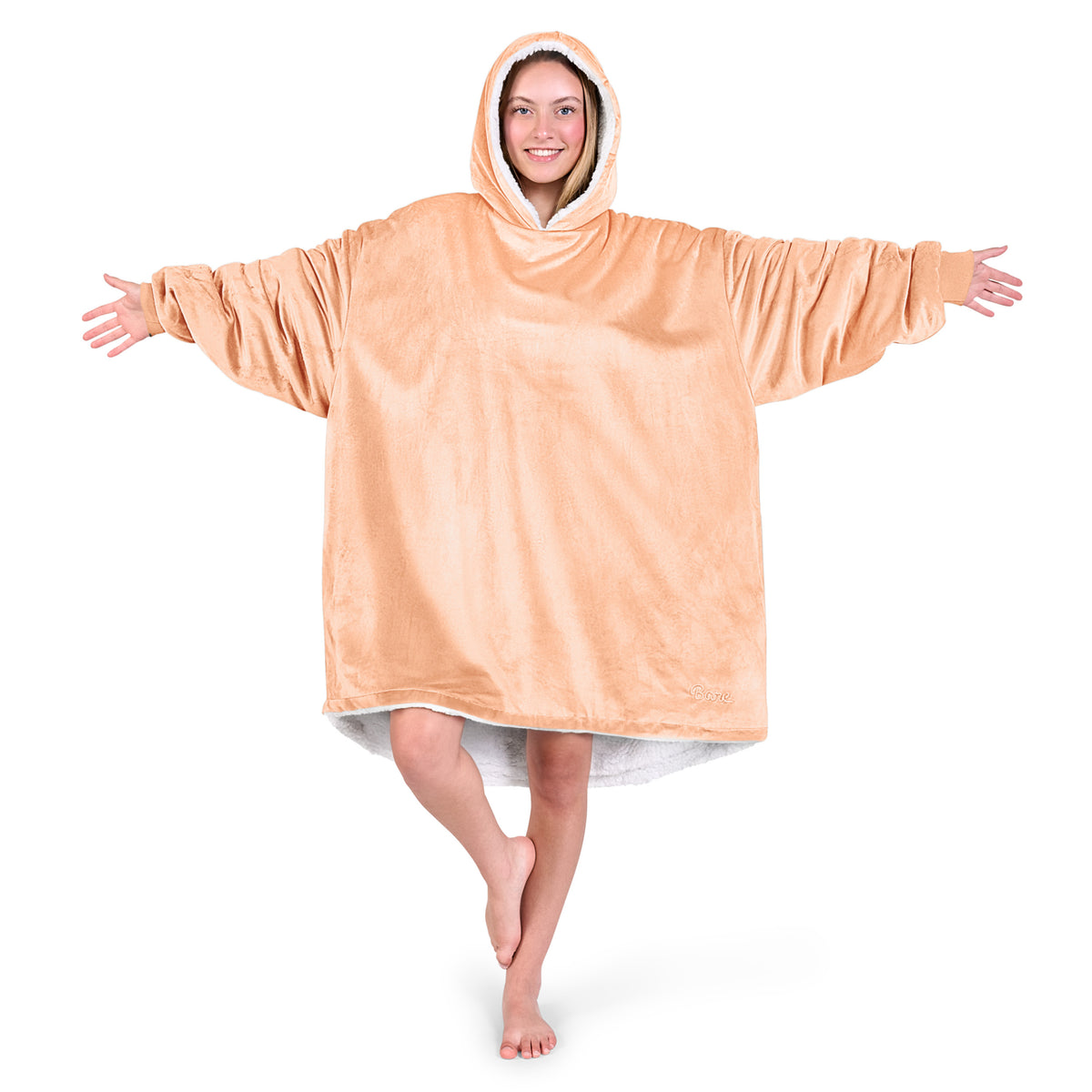 An adult with a sherpa wearable blanket on