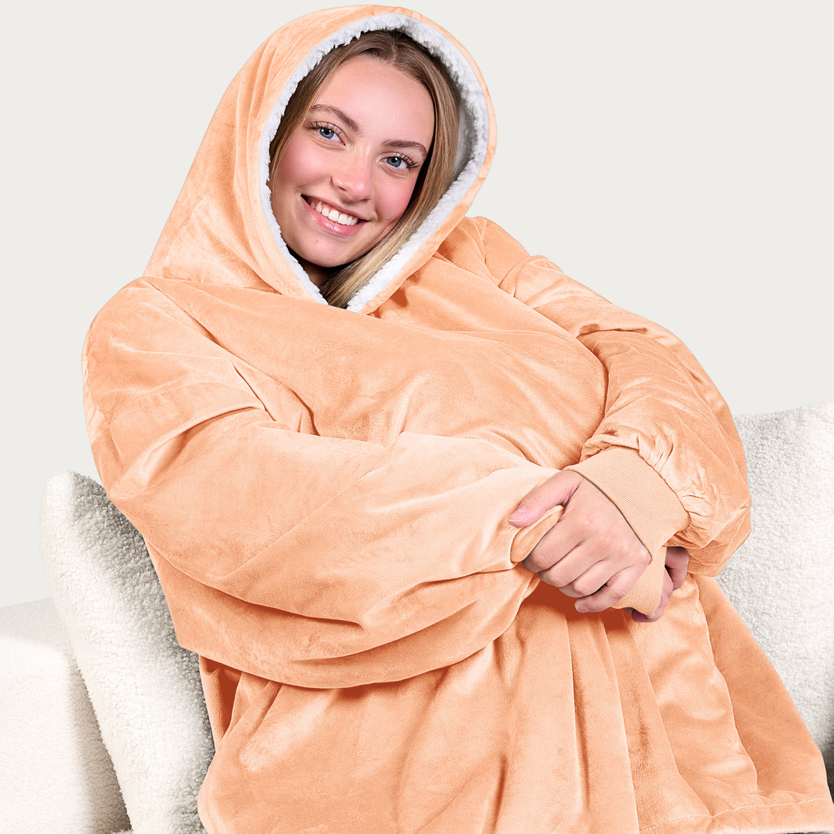 An adult with a sherpa wearable blanket on