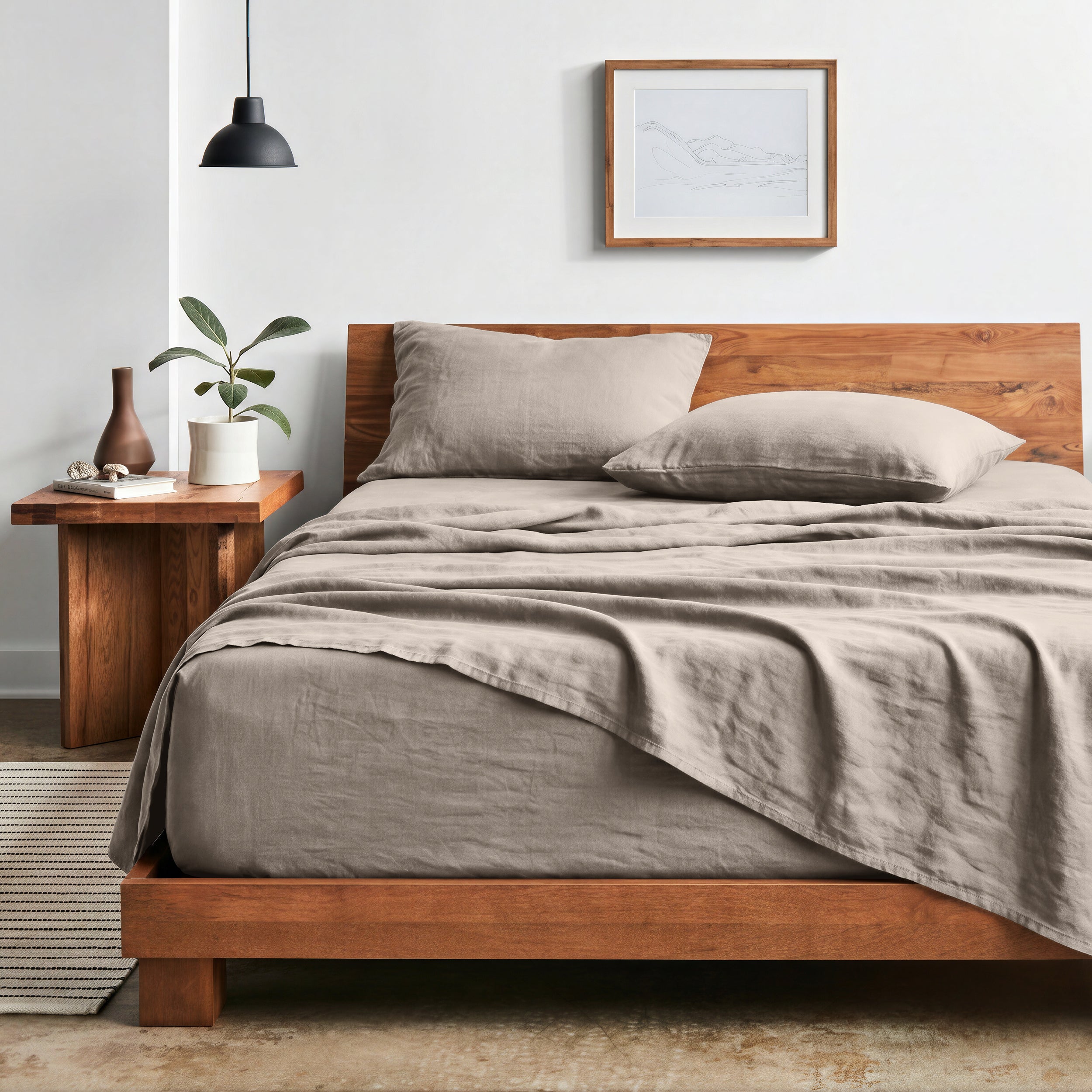 Bedroom with sheet set on a wooden bed frame and side table