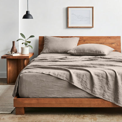 Bedroom with sheet set on a wooden bed frame and side table