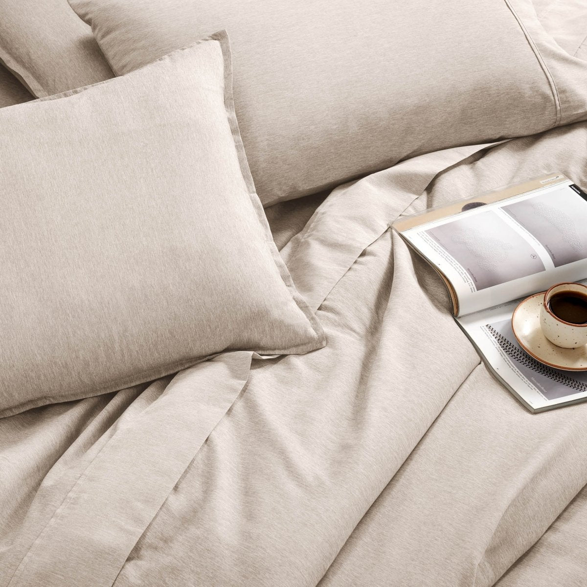 Bedding set with an open book and a cup on a saucer.