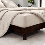 The  corner of a bed with a matching sheet set and comforter set on the bed.