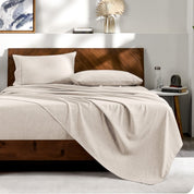 View from the end of a bed with matching sheets and pillowcases.