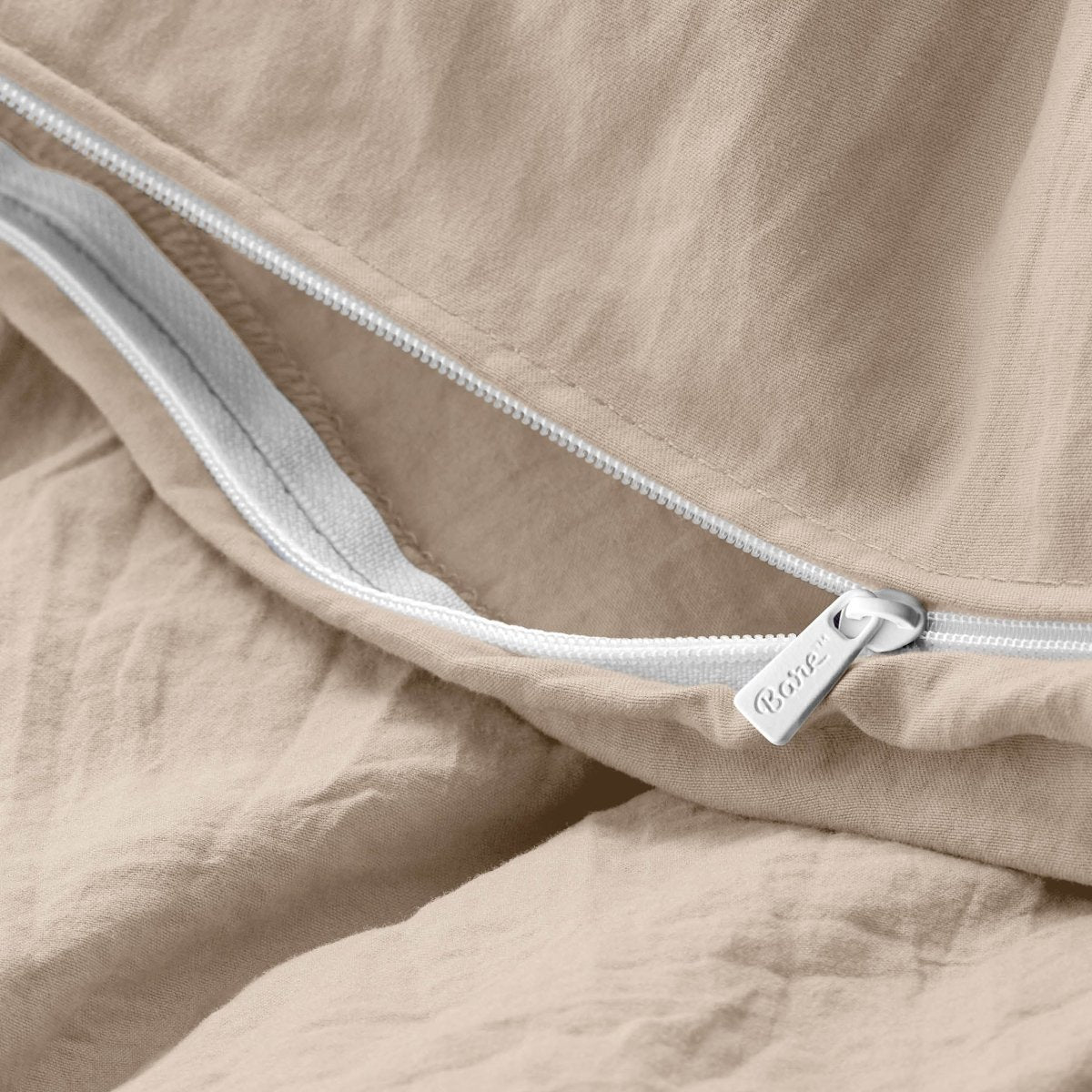 Close-up of a duvet cover with a zipper, featuring the brand Bare Home