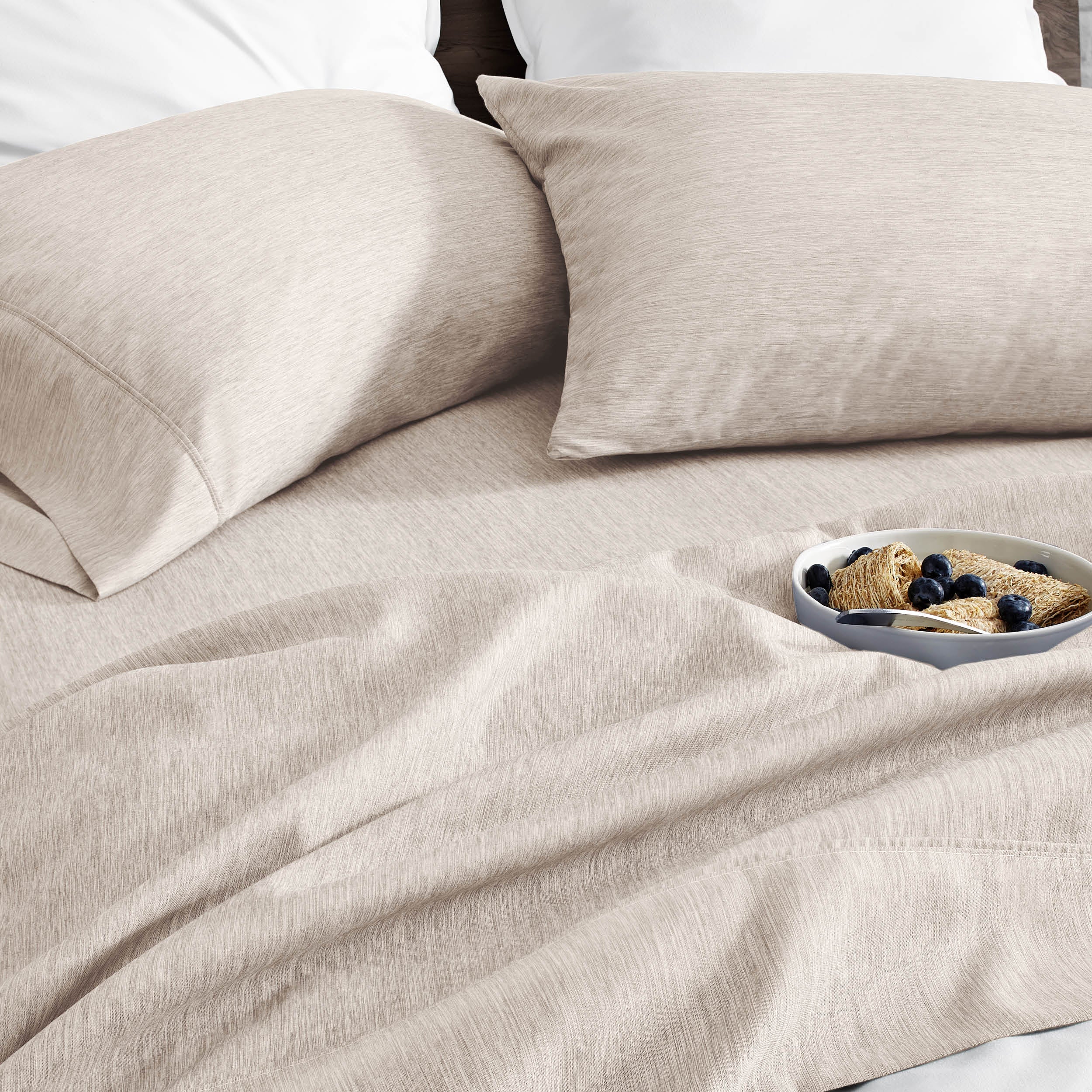 Ultra soft sheet set with a bowl of food on a bed