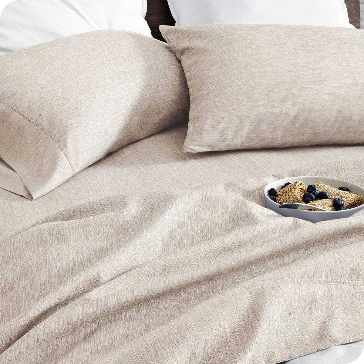 Bedding set on a bed with a bowl of cereal on a white background