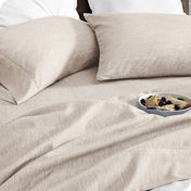 Bedding set on a bed with a bowl of cereal on a white background