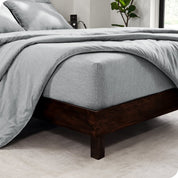 The  corner of a bed with a matching sheet set and comforter set on the bed.