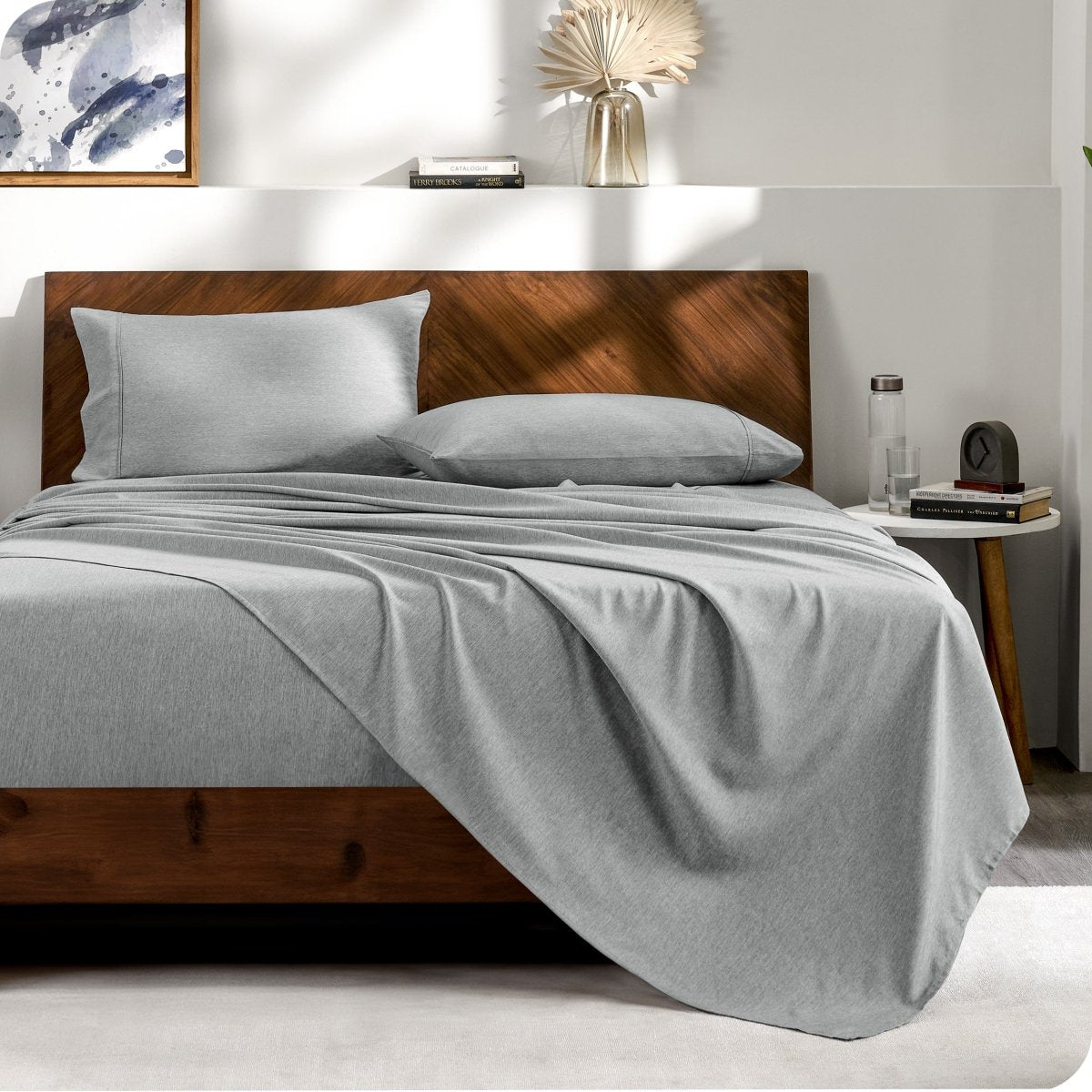 View from the end of a bed with matching sheets and pillowcases.
