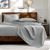View from the end of a bed with matching sheets and pillowcases.