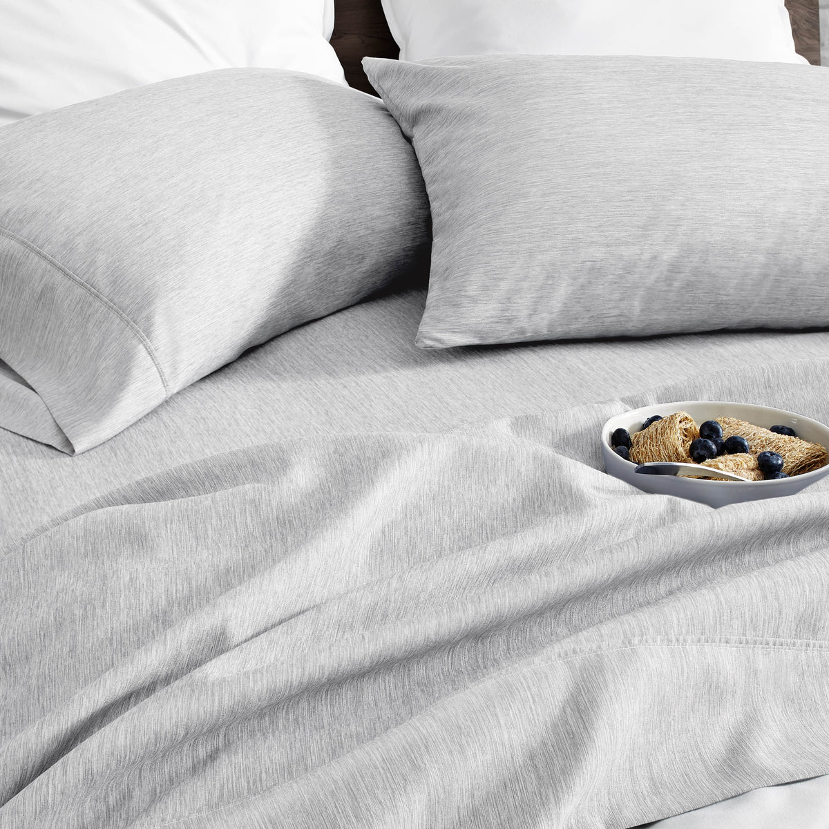 Ultra soft sheet set with a bowl of food on a bed