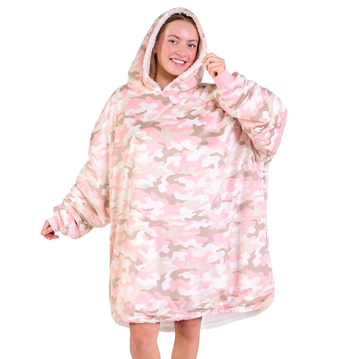 An adult with a sherpa wearable blanket on