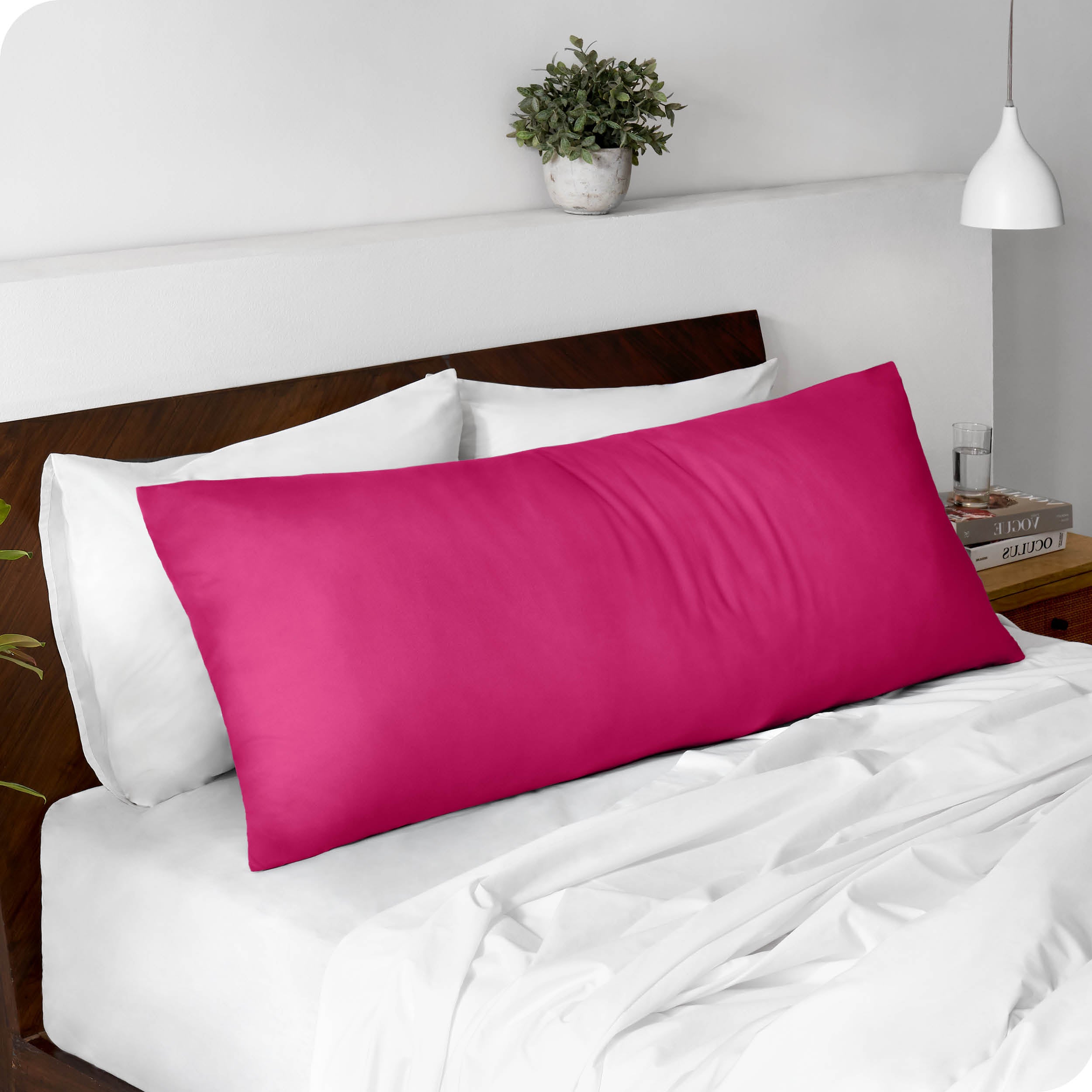 A body pillowcase on a pillow set against a headboard