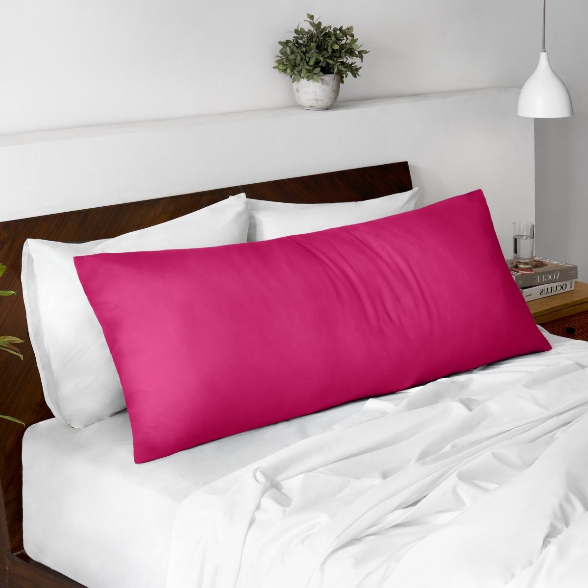 Body pillow on a bed with a wooden headboard and minimal decor.
