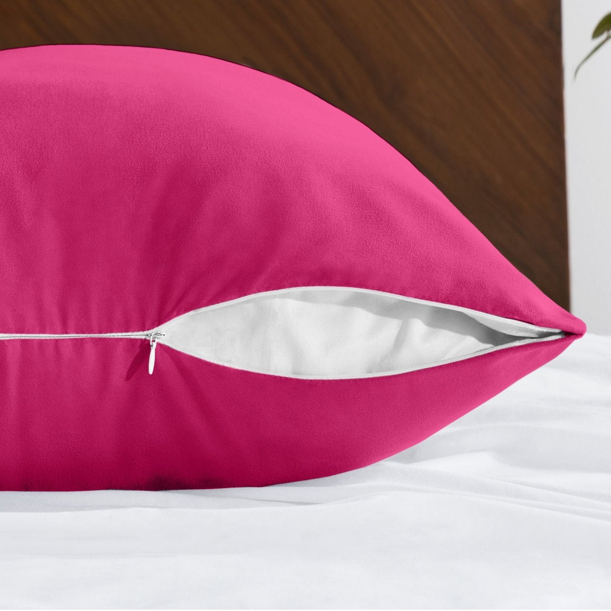Body pillowcase with a zipper closure on a bed with a wooden headboard