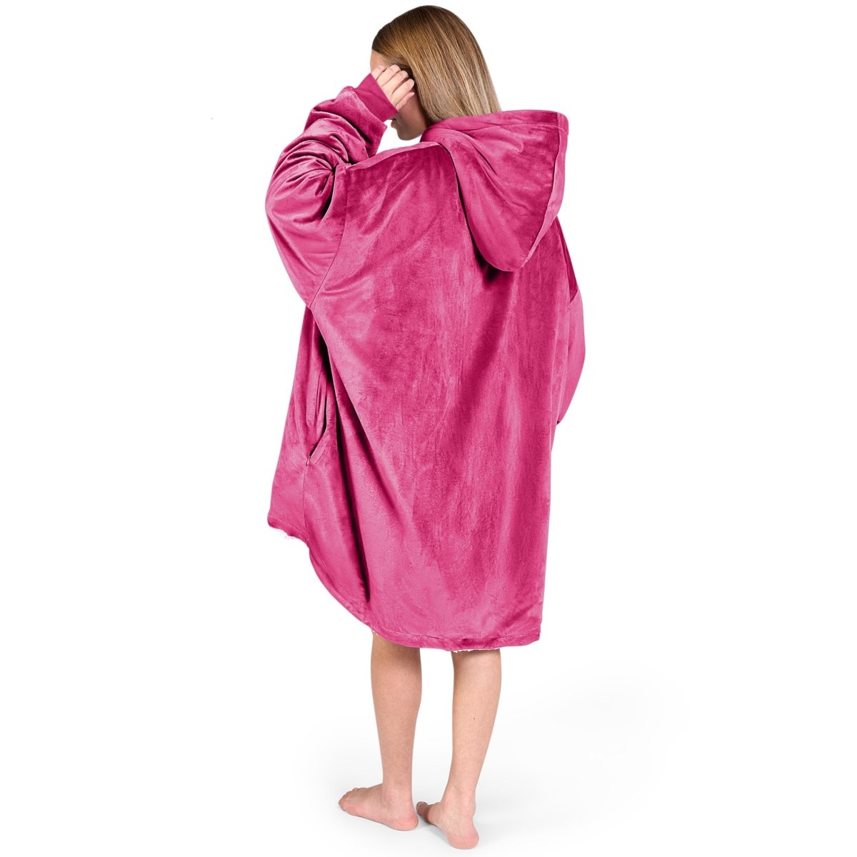An adult with a hooded wearable blanket on