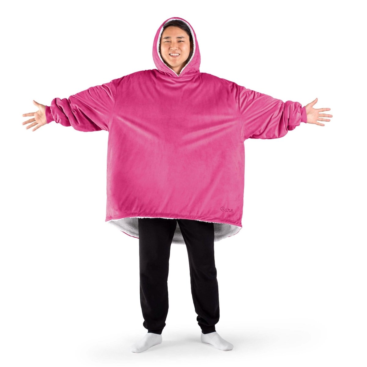An adult with a sherpa wearable blanket on