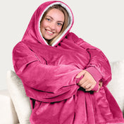 An adult with a hooded wearable blanket on