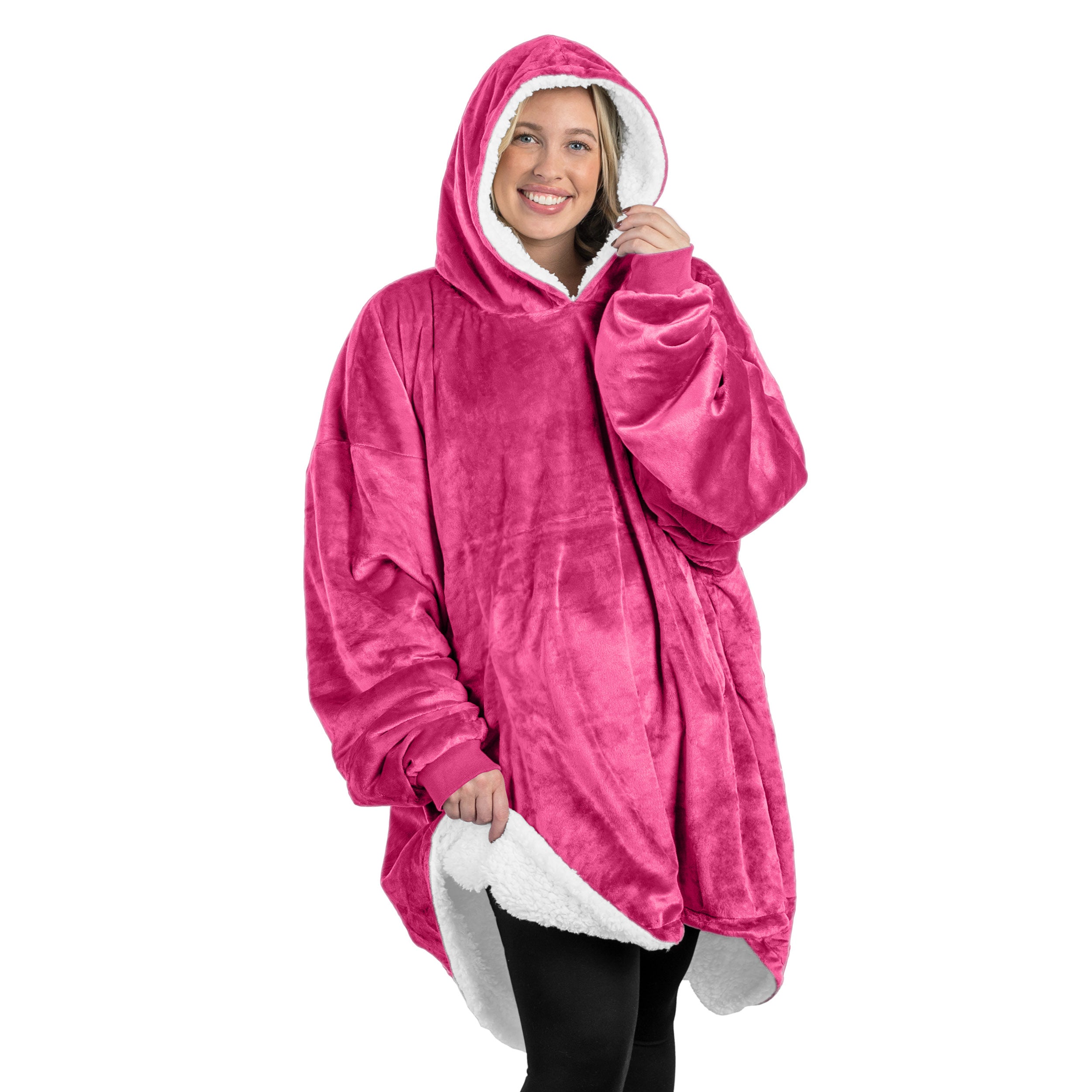 A oversized sherpa wearable blanket with a hood on a woman.