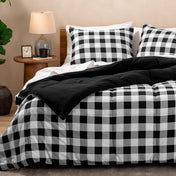 Bed with black and white checkered bedding in a bedroom setting.