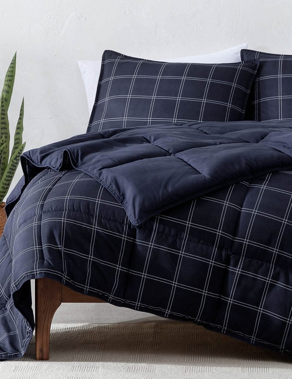 A modern bed with a down alternative comforter set on it