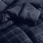 Navy blue checkered comforter on a bed