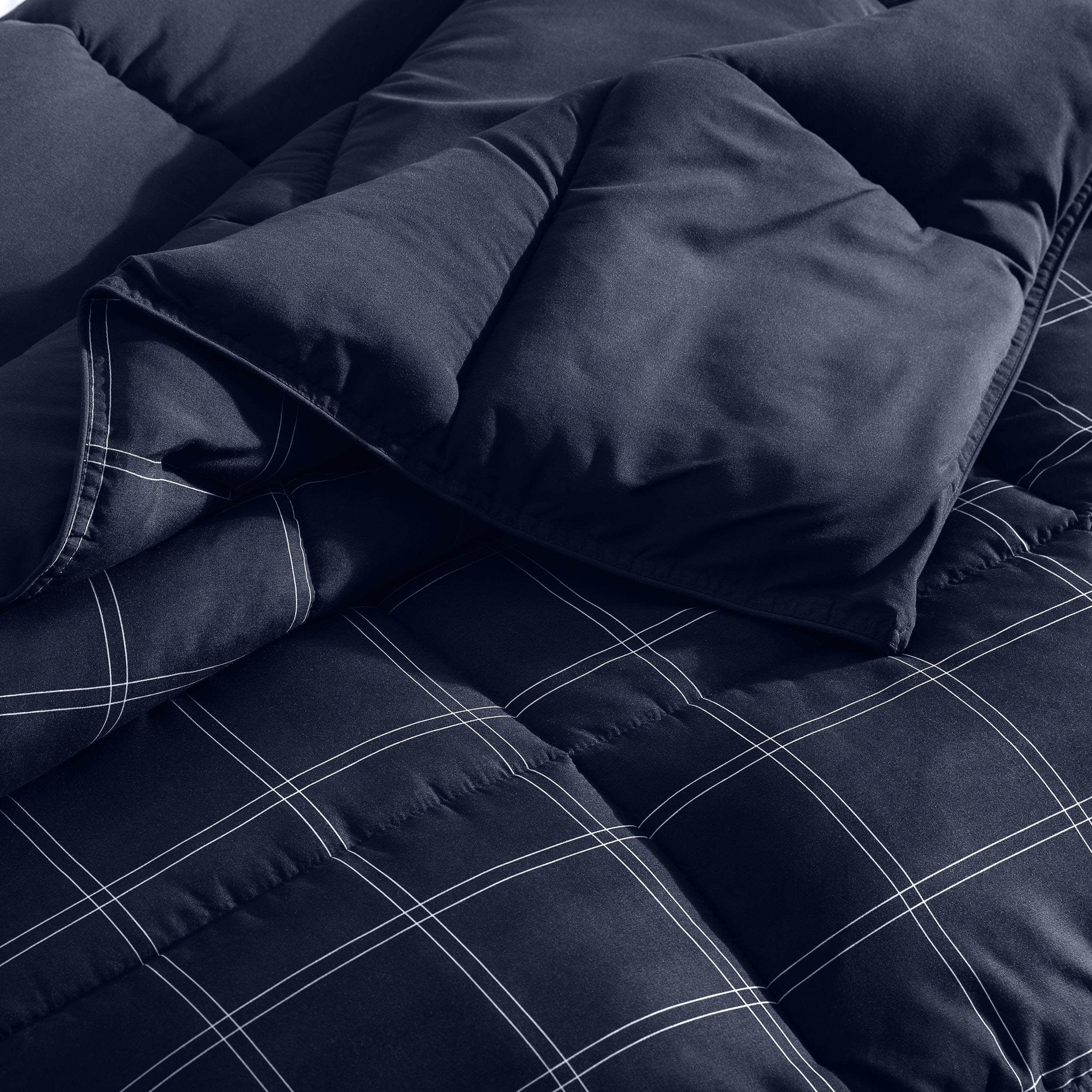 Navy blue checkered comforter on a bed