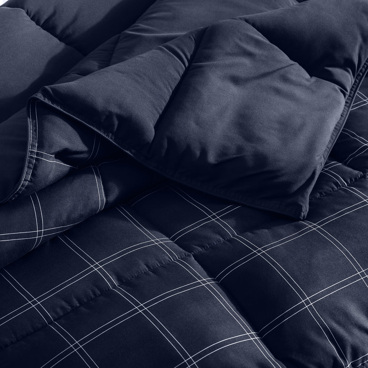 Navy blue checkered comforter on a bed