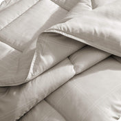 Close up of a print comforter folded over to show both sides.