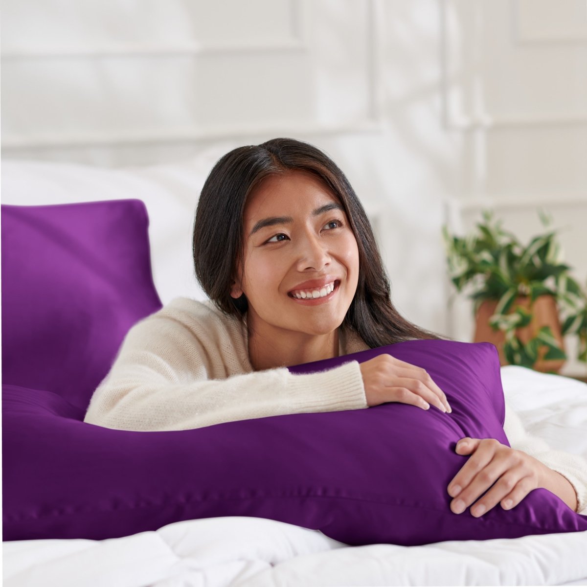 Woman lying on abed with a silk pillowcase