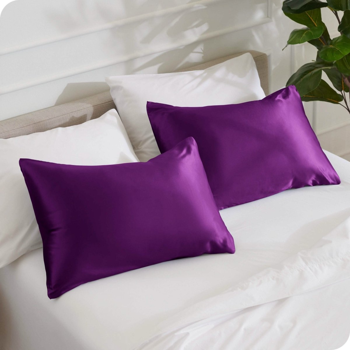 2 mulberry silk pillowcases on pillows set on a bed