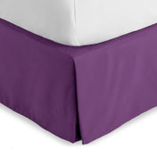 Bed skirt on a bed with white bedding