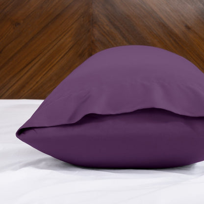 Body pillowcase with an envelope closure on a bed with a wooden headboard