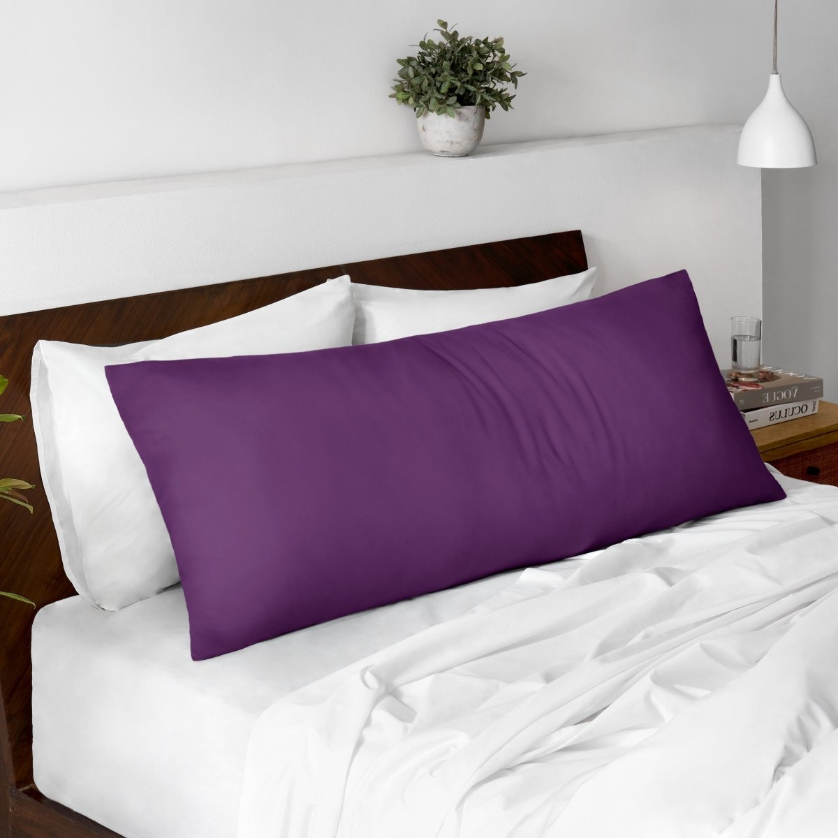 Body pillow on a bed with a wooden headboard and minimal decor.