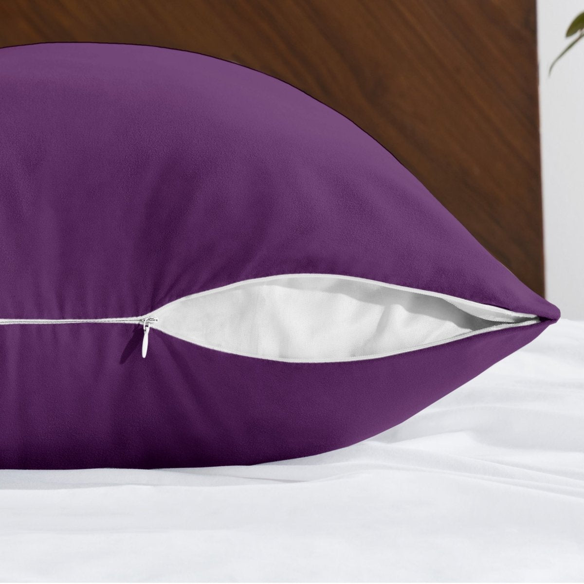 Body pillowcase with a zipper closure on a bed with a wooden headboard