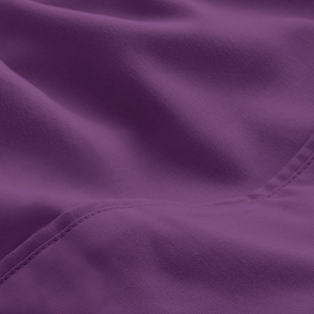 A close-up of microfiber fabric with soft folds and a visible stitched seam.