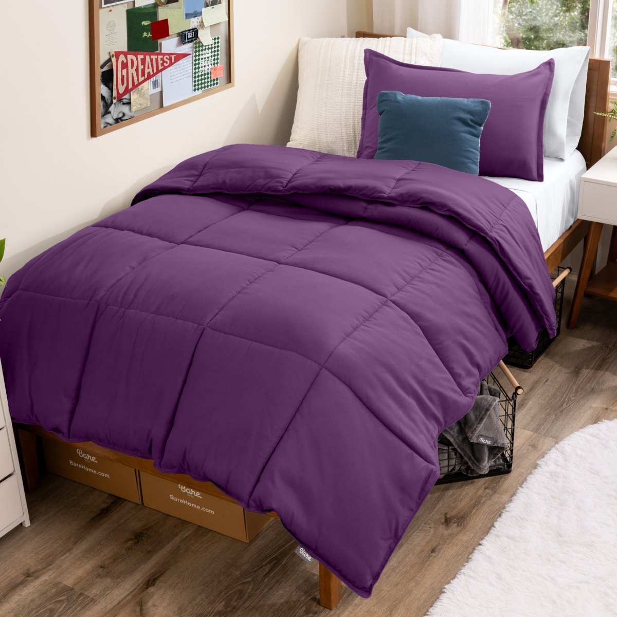 Bed with comforter and pillows in a dorm room